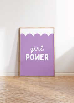 a purple poster with the words girl power on it in front of a white wall