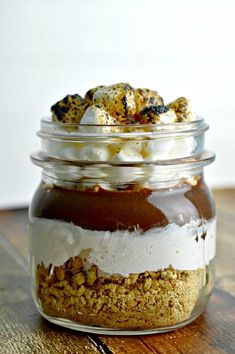 a glass jar filled with food on top of a wooden table