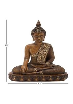 a buddha statue sitting on top of a table