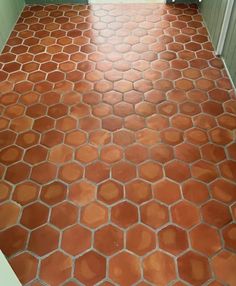 an orange tiled floor in a bathroom