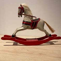 a toy rocking horse on top of a wooden table