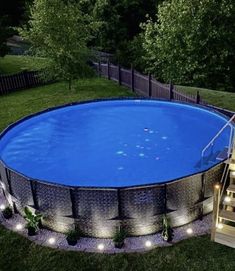 an above ground swimming pool with steps leading up to it and lights on the side