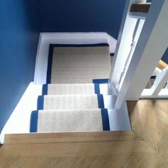 the stairs are painted blue and white with carpeting on them in an area that looks like it has been cleaned