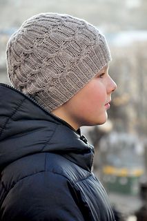 a young boy wearing a gray knitted hat