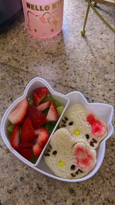 a hello kitty bento box with strawberries in it