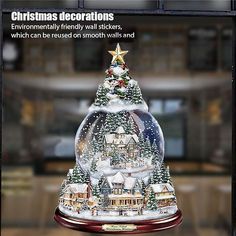 a snow globe with a christmas tree on top and an advertise for the company