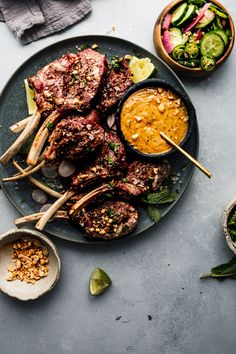 a plate full of food with chopsticks and dipping sauce on it next to other dishes