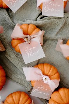 small pumpkins are wrapped in pink ribbon and tied together with tags that read, you're married