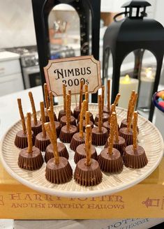 there are chocolates on the plate with sticks sticking out of them and a sign that says nimbus 2009