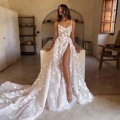 a woman in a white wedding dress posing for the camera with her legs spread out