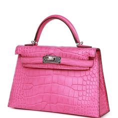 This tiny Kelly, in the Sellier style, is in Rose Shocking matte Mississippiensis alligator with palladium hardware and has tonal stitching, two front straps with front toggle closure, single rolled handle and removable shoulder strap.The interior is lined with Rose Shocking leather and has one open pocket on the back wall.Collection: ZOrigin: FranceCondition: New (plastic on hardware)Accompanied by: Hermès box, Hermès dustbag, shoulder strap, shoulder strap dustbag, felt, carebook, rainhat, CITES Measurements:﻿ 7.5" width x 4.5" height x 2.2" depth; 2.5" handle drop, 18.5" Shoulder Strap dropDelivery 5-8 or 10-15 working days Please note that during high season and Sale period, delivery times may be affected We accept payment with a Credit card, Debit card, or PayPal.Note: Our Items are t Rose Shock, Hermes Kelly Sellier, Kelly Sellier, Hermes Bags, Diaper Backpack, Brunei, Luxury Handbags, Womens Backpack, Alligator