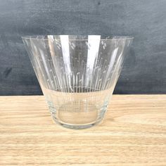 a clear glass bowl sitting on top of a wooden table