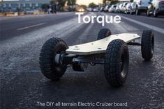 an electric skateboard is shown on the street with words torque in front of it