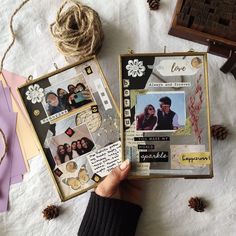 someone is holding up a scrapbook with pictures and pine cones on the table next to it