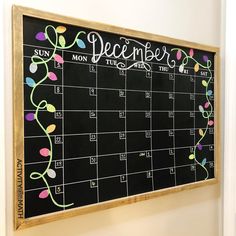 a chalkboard calendar hanging on the wall