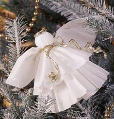 a white ornament hanging from the side of a christmas tree