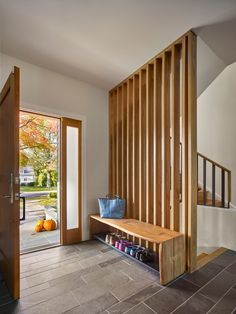 a wooden bench sitting in front of a doorway