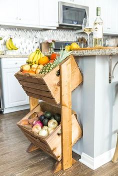 a kitchen island made out of crates filled with fruit