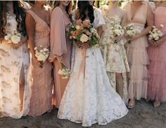 a group of women standing next to each other wearing dresses and holding bouquets in their hands