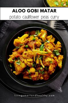 a black plate topped with cauliflower and curry