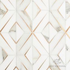 a white marble tile with gold lines on it