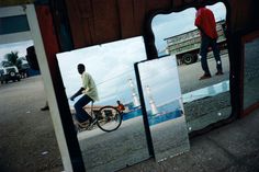 a man riding a bike in front of a mirror