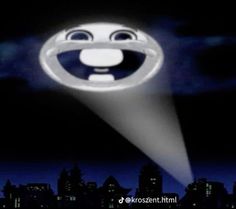 an animated image of a smiley face in the middle of a dark city at night