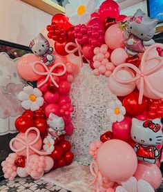 hello kitty balloon arch in the shape of a house