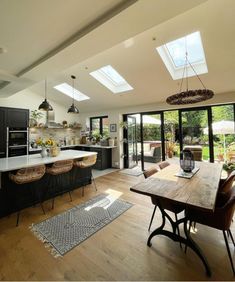 an open kitchen and dining room with skylights