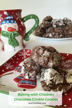 chocolate crinkle cookies are stacked on a plate next to a cup and mug