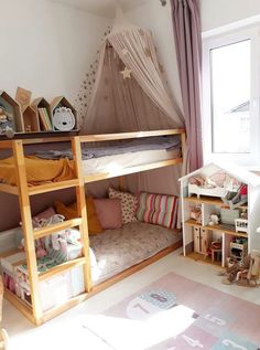 a child's bedroom with bunk beds and toys