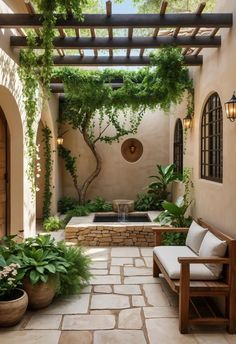 an outdoor patio with stone flooring and potted plants on either side of it