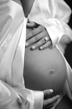 a pregnant woman's belly is shown in this black and white photo with text