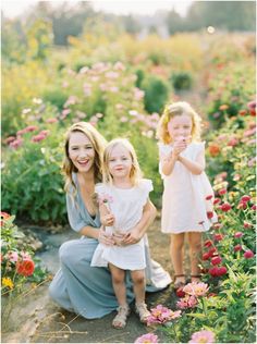 two girls and their mom in a flower field