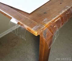 a wooden table with clear plastic covering on it