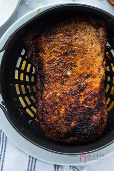 a close up of a frying pan with food in it on top of a table