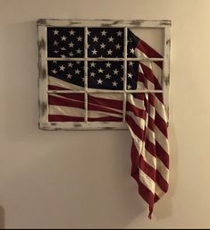 an american flag hanging on the side of a window