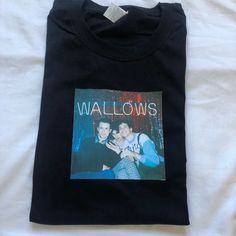 Wallows band custom tee printed by me! This print is printed onto quality fruit of the loom white T-shirt's and is available in sizes Small Medium Large and Extra large. I also do custom tees so feel free to message😚 90s Style Black T-shirt With Custom Print, Black Custom Print 90s T-shirt, Band Merch Cotton T-shirt With Custom Print, Custom Print Cotton T-shirt Band Merch, Custom Print Fan Merchandise T-shirt, Unisex Custom Print T-shirt For Fan Merchandise, Unisex Custom Print T-shirt For Fans, Black T-shirt With Heat Transfer Vinyl Band Merch, Unisex Crew Neck T-shirt With Heat Transfer Vinyl