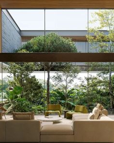 the living room is filled with furniture and large windows