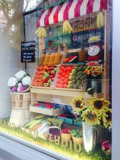 a display in a store filled with lots of fruits and veggies for sale