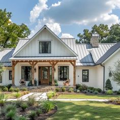 a large white house with a metal roof