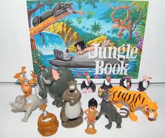 the jungle book is surrounded by various figurines