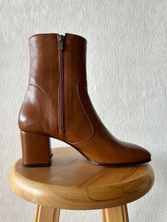 Handmade Tan Leather Boots for Women | Stylish Women's Tan Boots | Custom Tan Leather Booties | Trendy Women's Footwear Key Features: * Handmade Quality: Each pair is carefully handcrafted. *  Tan Leather: Features a vibrant tan  leather finish for a glossy, eye-catching look. * Versatile Design: Suitable for a variety of occasions, from casual outings to elegant events. * Durable Construction: Made with high-quality materials for long-lasting wear and durability. Ideal for: *  Everyday Wear: Pair with jeans or leggings for a chic, standout look. * Perfect for Dresses and Skirts: Perfect for adding a sophisticated touch to your favorite dresses and skirts. SIZE GUIDE Fables Mary Jane shoes are true to size. However, if you have a high instep or a wide foot, we would recommend sizing up. Al Cognac Womens Boots, Carmina Boots Women, Camal Boots, Womens Tan Leather Boots, Tan Womens Boots, Chameau Boots, Leather Boots For Women, Camel Boots, Tan Leather Boots