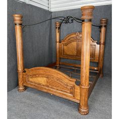 a wooden bed with four posts in a room