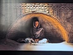 a woman is sitting in the middle of a tunnel