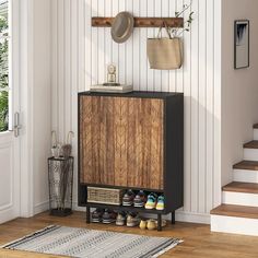 a wooden cabinet with shoes on it next to some stairs and a rug in front of the door