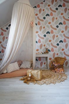 a child's bedroom with a canopy bed and stuffed animals on the floor next to it