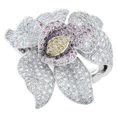 Cartier Caresse D'Orchidees pink, yellow and white diamond flower ring in platinum, accompanied by Cartier paperwork and Cartier box. This striking ring from Cartier's high jewelry collection features approximately 5.02 carats of pave set natural pink, yellow and white round brilliant cut diamonds. The flower top measures approximately 36mm. Size 53. Numbered and signed Cartier with French hallmarks. Pink Flower Ring, Natural Blue Diamond, Orchid Jewelry, Diamond Flower Ring, Flower Diamond Ring, High Jewelry Ring, Blue Diamond Ring, Flower Top, Jewelry Lookbook