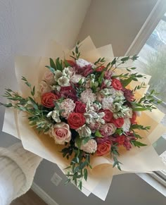 a bouquet of flowers sitting on top of a window sill