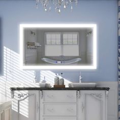 a bathroom with a sink, mirror and bathtub in the middle of the room